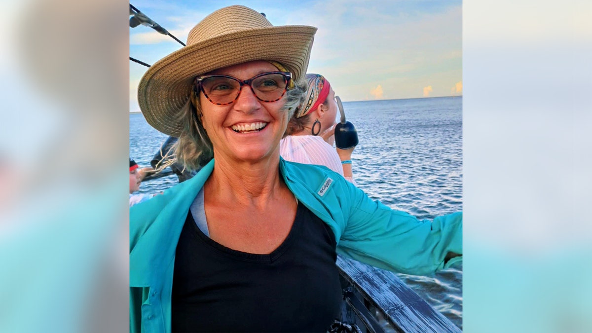 Lynette Hooker standing outdoors wearing a hat and sunglasses