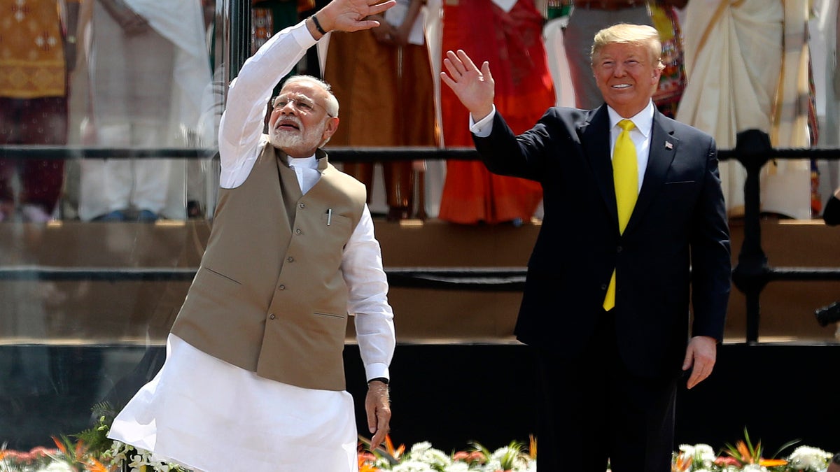 U.S. President Donald Trump and Indian Prime Minister Narendra Modi wave to the crowd at Sardar Patel Stadium in Ahmedabad, India, Monday, Feb. 24, 2020. India poured on the pageantry with a joyful, colorful welcome for President Donald Trump on Monday that kicked off a whirlwind 36-hour visit meant to reaffirm U.S.-India ties while providing enviable overseas imagery for a president in a re-election year. (AP Photo/Aijaz Rahi)
