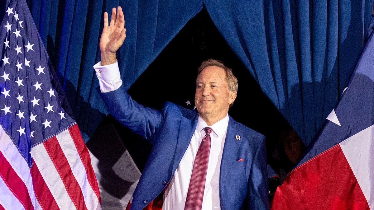 Ken Paxton standing and speaking at a runoff election night event in Plano, Texas.