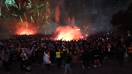 Flares are set off at Federation Square.