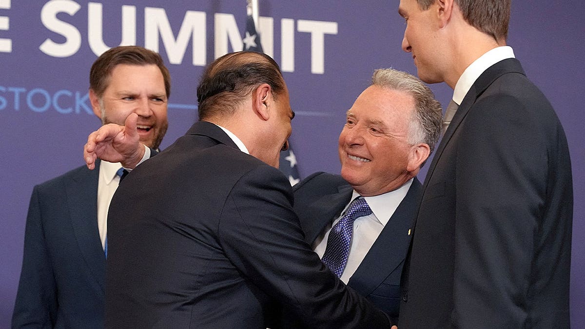 U.S. delegation greeting each other.