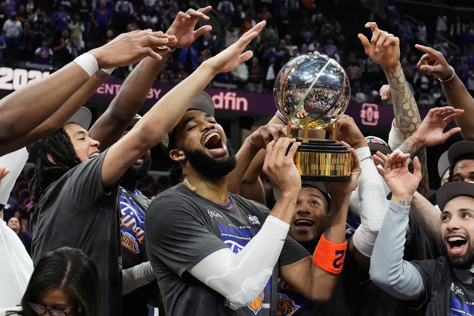 New York Knicks center Karl-Anthony Towns, center, and teammates celebrate after winning Game 4 in the NBA Eastern Conference Finals against the Cleveland Cavaliers on Cleveland's home court May 25. (AP Photo/Sue Ogrocki)