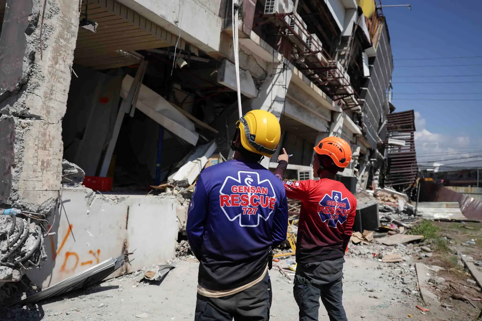 Rescuers inspect a damaged building following an earthquake in General Santos, Philippines, on June 9. (AP Photo/Basilio Sepe)