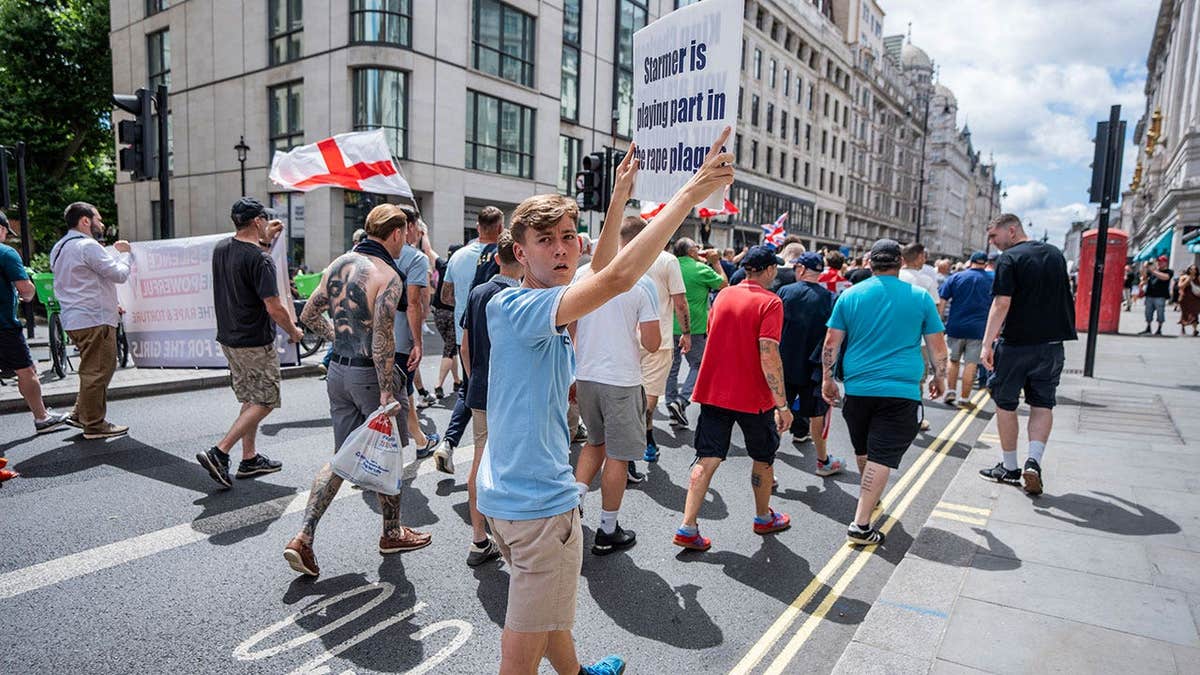 protestor holds a placard accusing the Prime Minister Sir Keir Starmer of ignoring the Grooming Gang scandal during a rally
