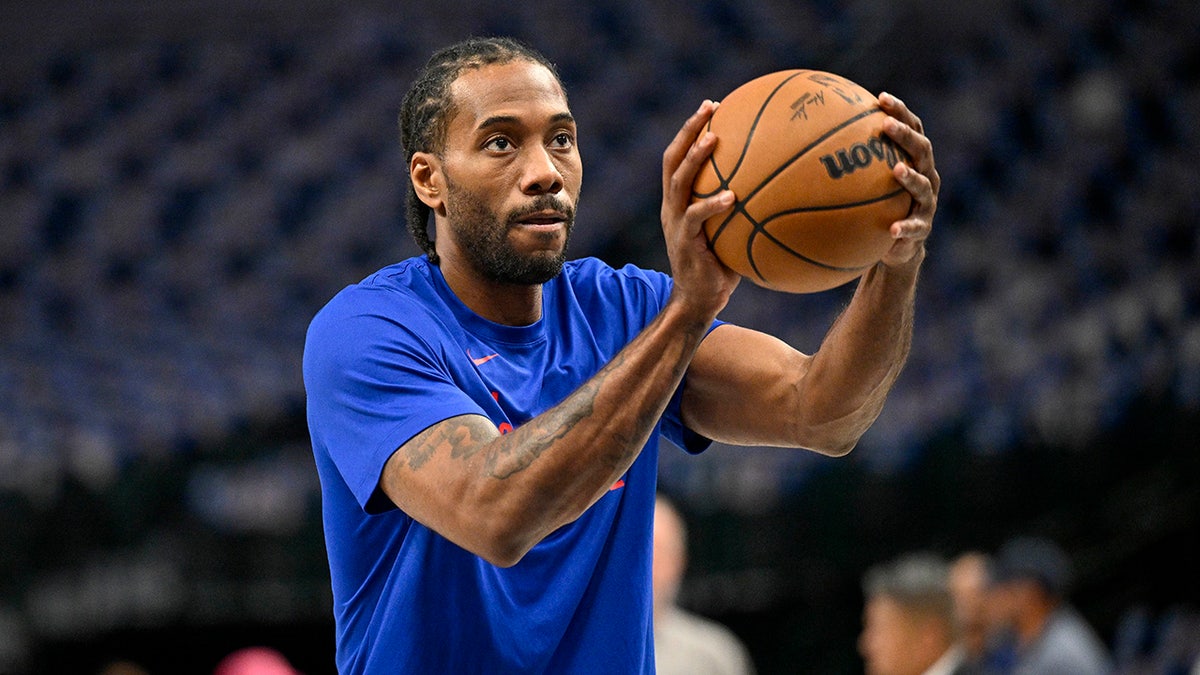 Kawhi Leonard warming up on basketball court before game at American Airlines Center