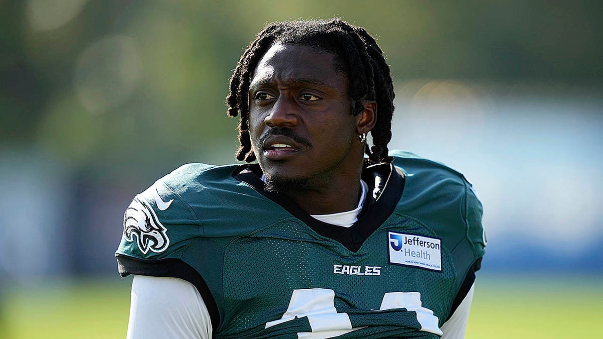 Philadelphia Eagles wide receiver A.J. Brown walking on a football field during training camp