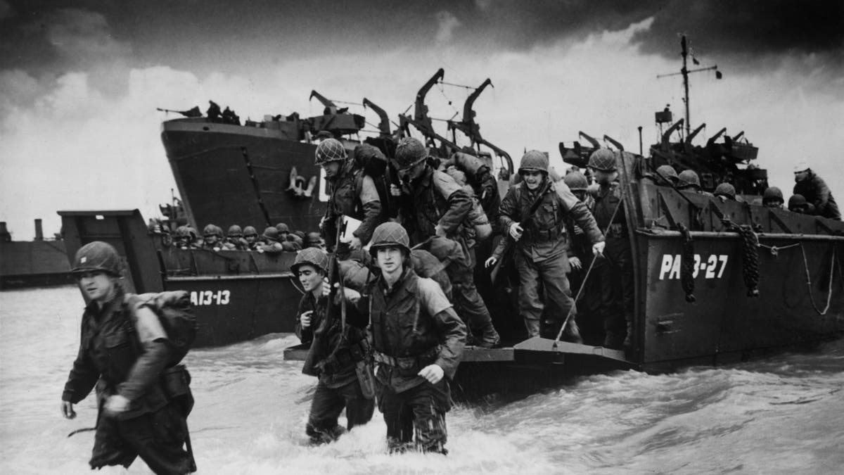Reinforcements disembarking from a landing barge at Normandy beach