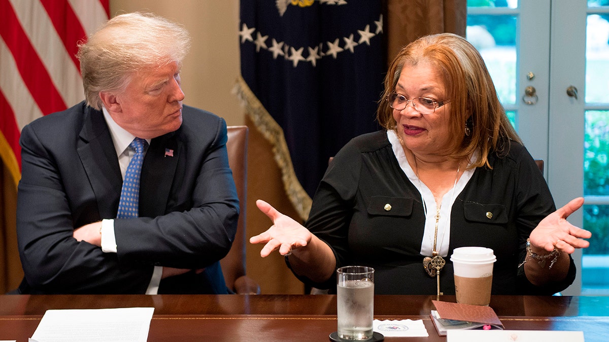 President Donald Trump listening to Dr. Alveda King during a meeting at the White House