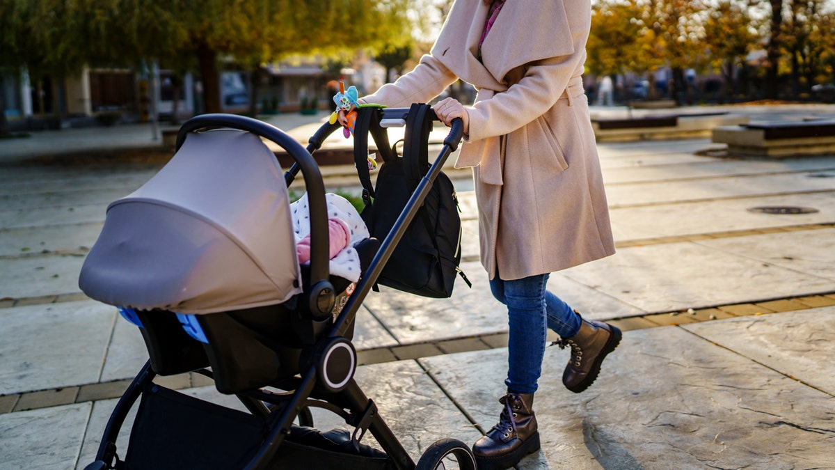 woman pushing stroller