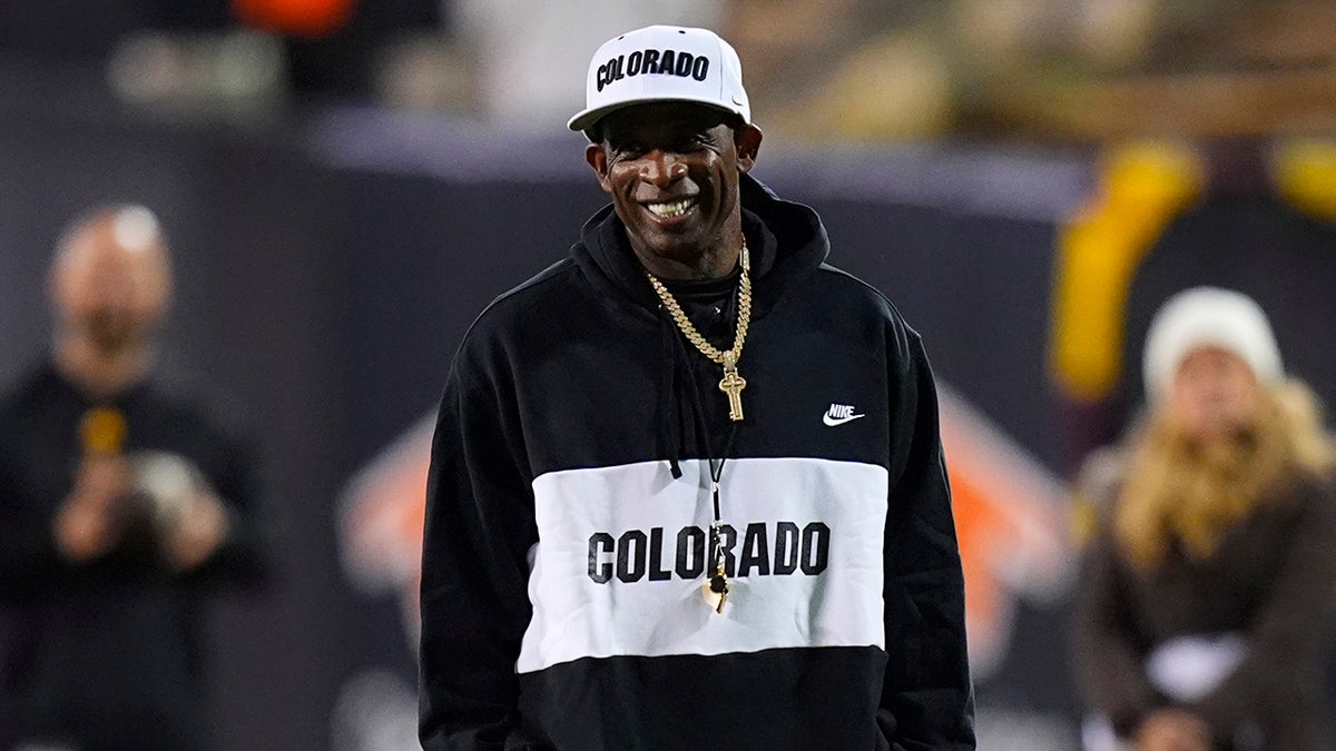 Colorado Buffaloes head coach Deion Sanders standing on the sidelines at Folsom Field.