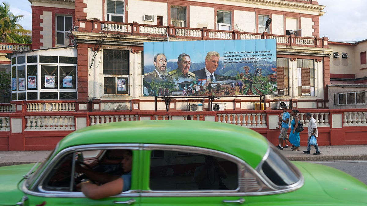 Poster of late Cuban President Fidel Castro, Cuba's former President Raul Castro and Cuba's President and First Secretary of the Communist Party Miguel Diaz-Canel