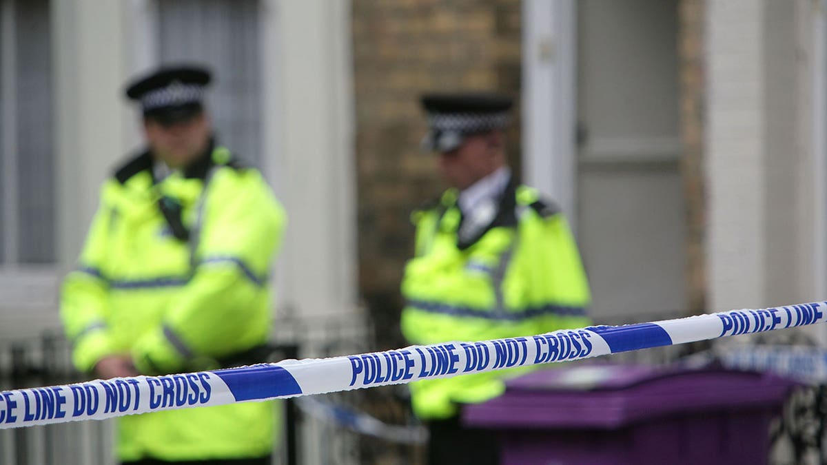Police officers standing outside a house on Hatherley Street in Liverpool