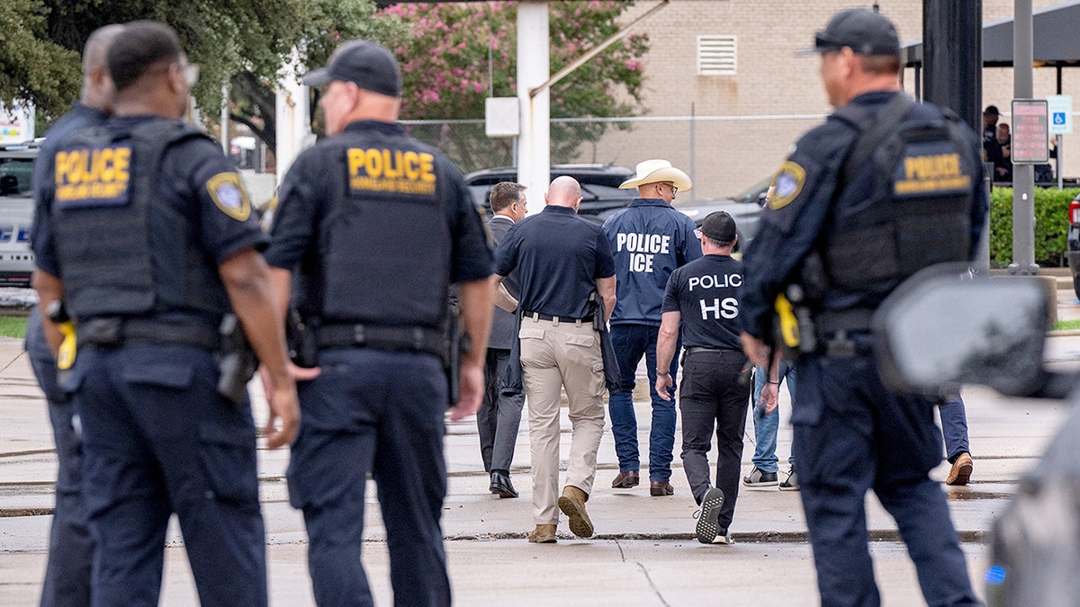 Law enforcement personnel responding at the scene of a shooting at an ICE field office in Dallas
