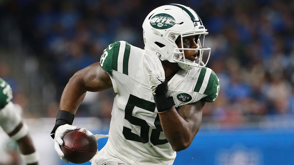 Darron Lee of the New York Jets running with the football at Ford Field.