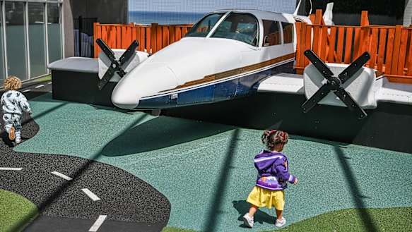 Woodlands Long Day Care & Kindergarten, in St Kilda Road. Children play in front of a plane, which Woodlands had installed using a crane.