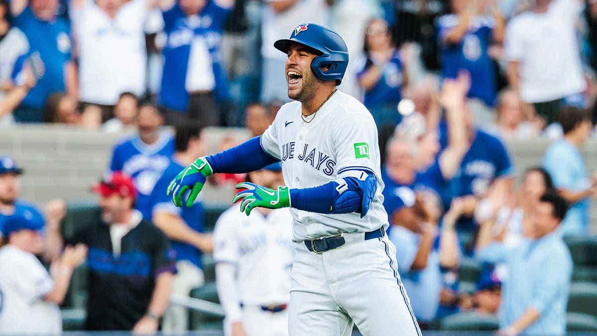 George Springer running after scoring during a baseball game at Rogers Centre in Toronto