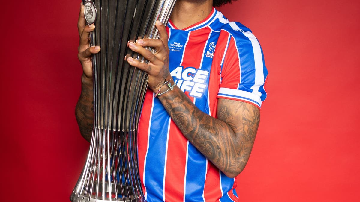 Chris Richards posing with the UEFA Conference League Trophy, along with Paxo the chicken. (Photo by Boris Streubel - UEFA/UEFA via Getty Images)
