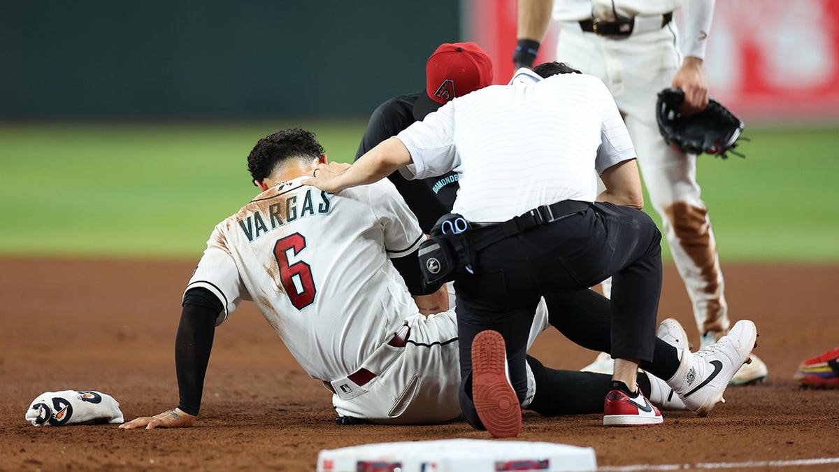 Arizona Diamondbacks first baseman Ildemaro Vargas receiving medical attention on the field at Chase Field
