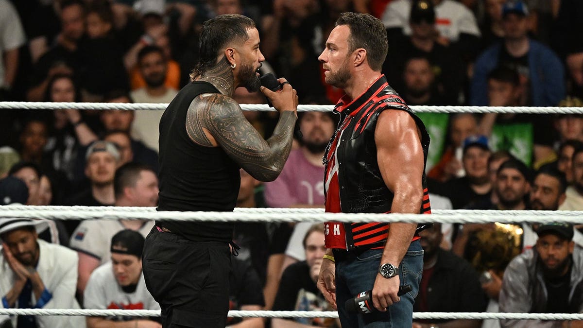 Jey Uso and LA Knight facing off in a wrestling ring at The Accor Arena in Paris