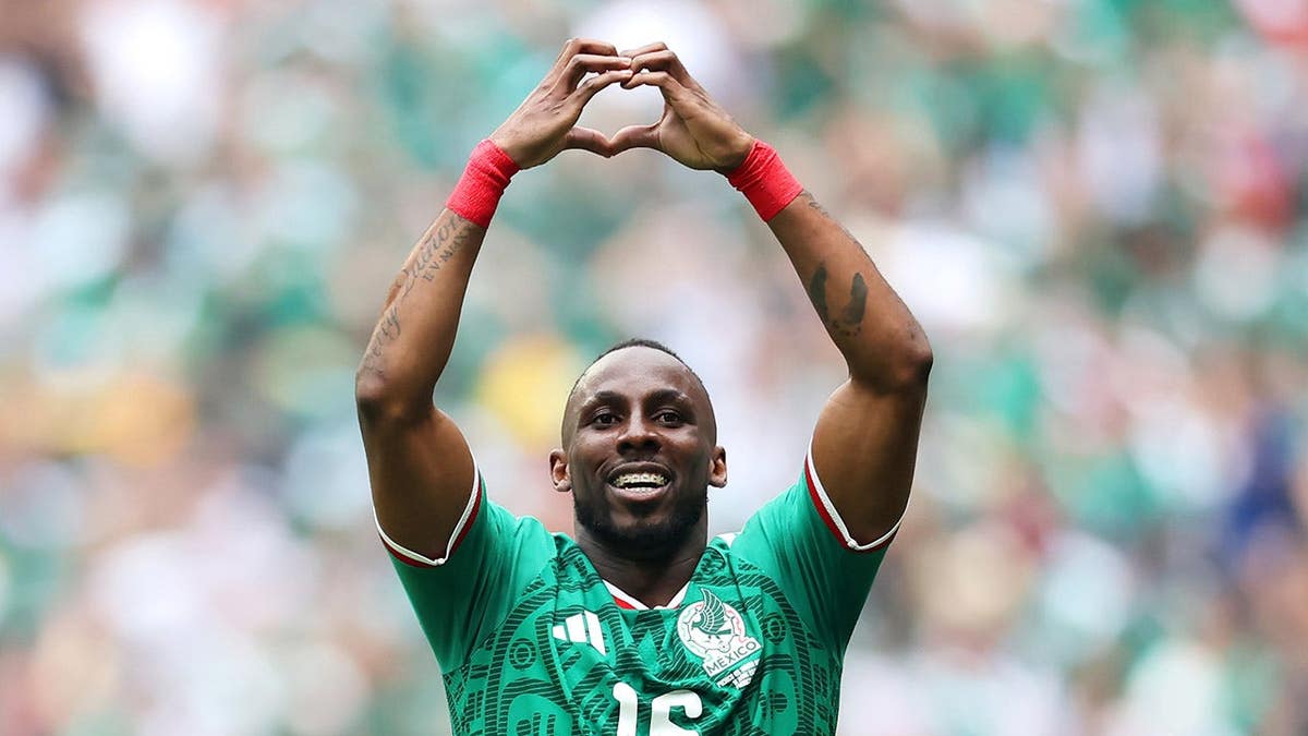 Julian Quinones celebrating after scoring a goal during a soccer match in Mexico City.