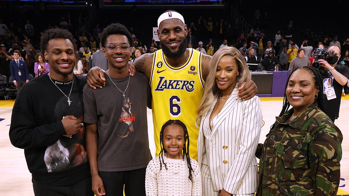 LeBron James posing with his family at Crypto.com Arena in Los Angeles