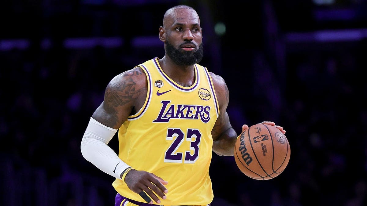 LeBron James dribbling basketball on court during game