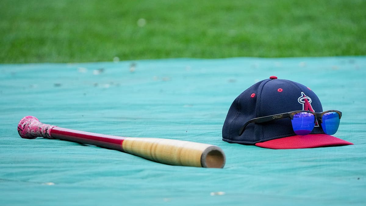 Los Angeles Angels bat hat and sunglasses on a table at Kauffman Stadium
