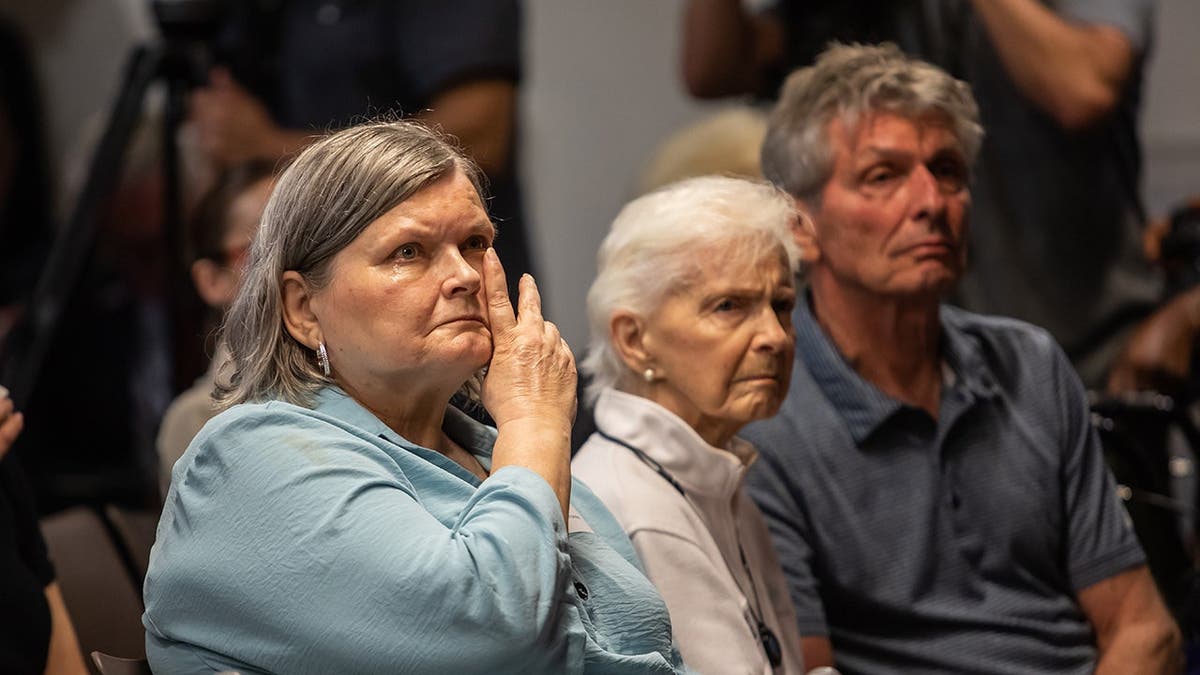 Diane Hernandez, Joan VanderMolen, and Arnold VanderMolen reacting during a press event in Los Angeles