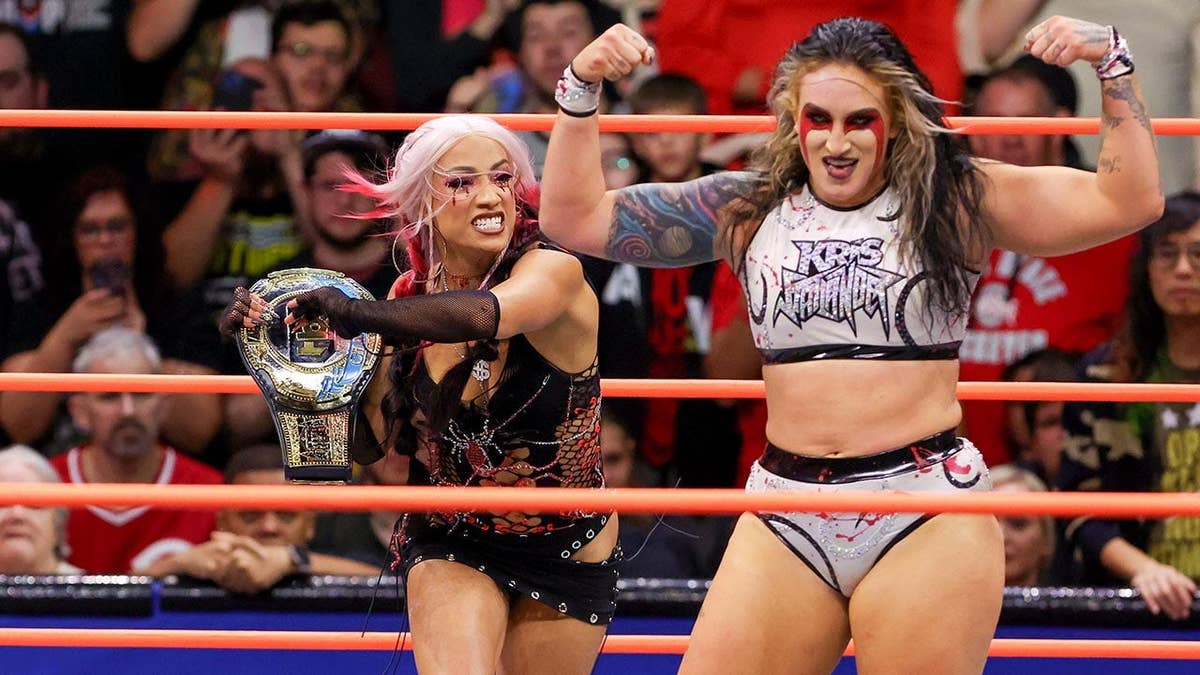 Mercedes Mone attacking Kris Statlander with championship belt in wrestling ring