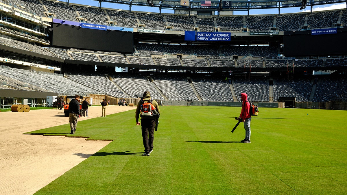 Workers installing the pitch at MetLife Stadium in East Rutherford, New Jersey