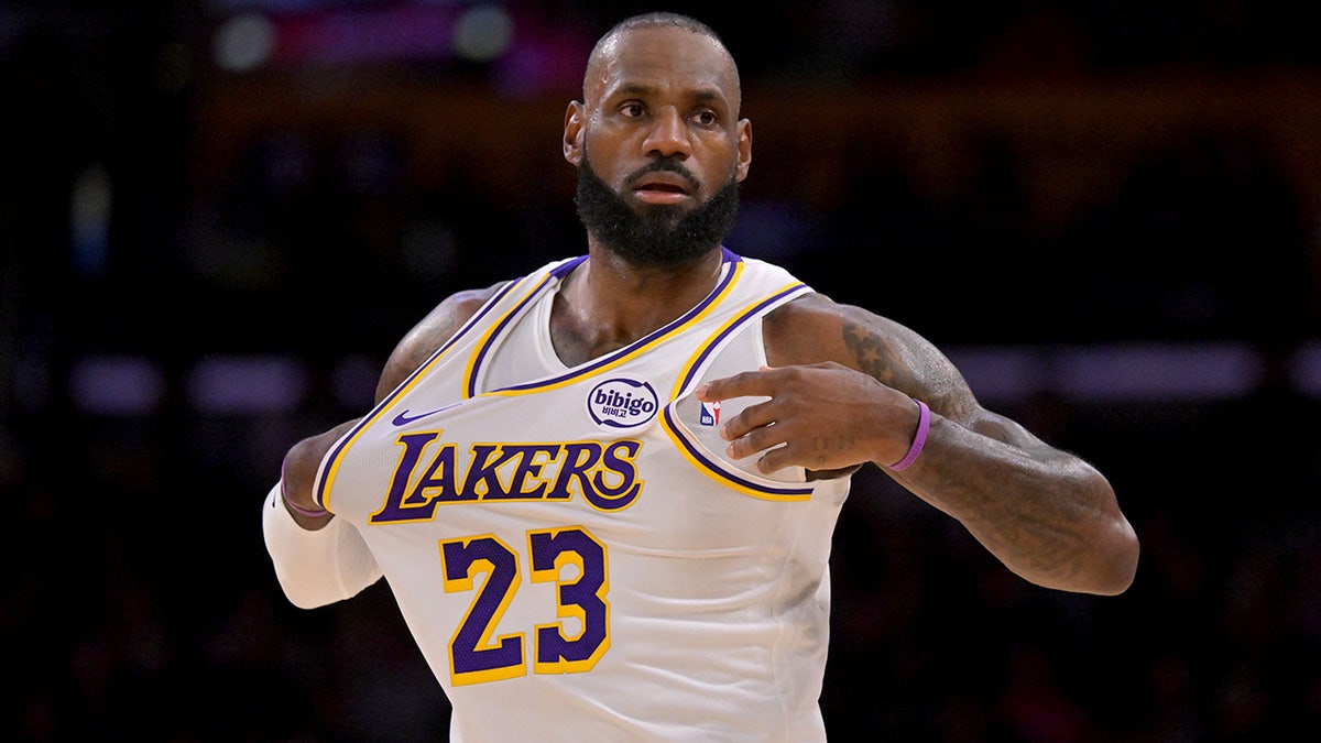 Los Angeles Lakers forward LeBron James adjusting his chest on the basketball court.