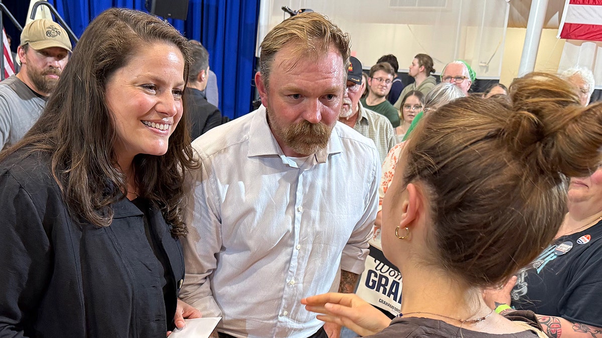 Platner and his wife standing together at a primary election event