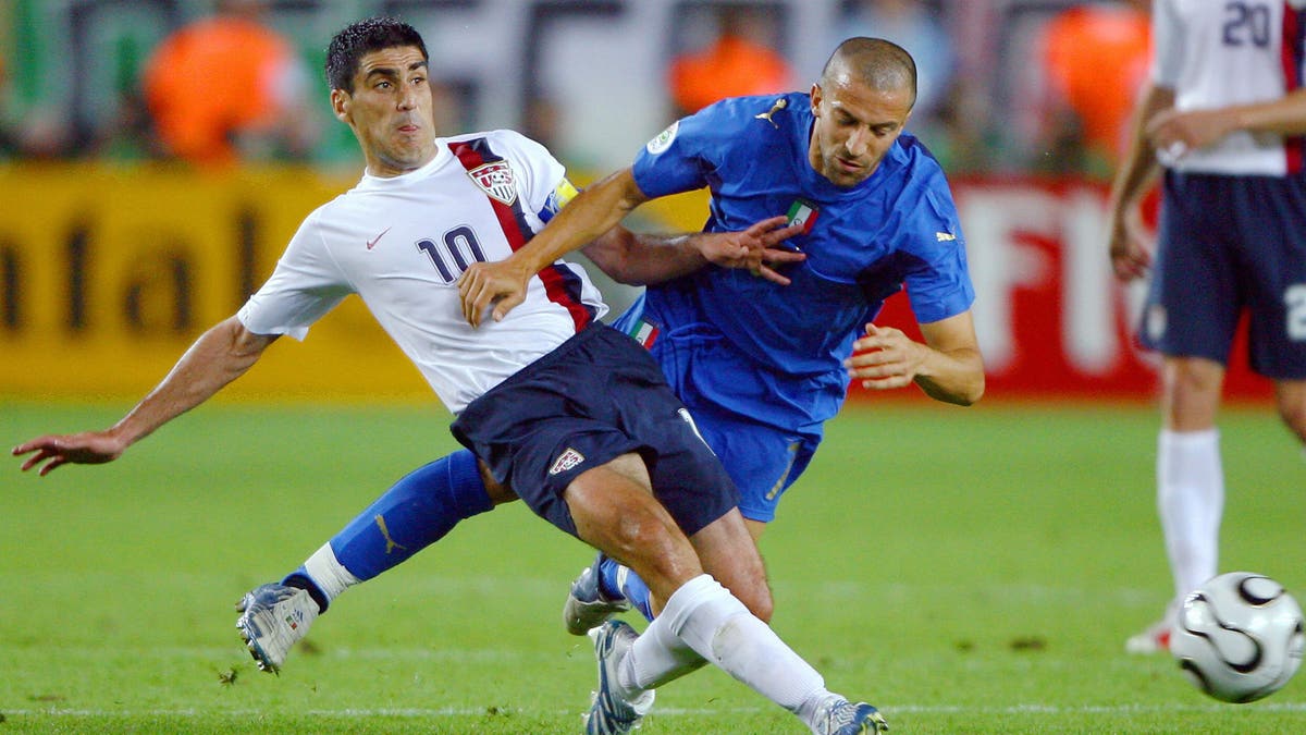 Claudio Reyna taking on Italy at the 2006 World Cup. (PATRICK HERTZOG/AFP via Getty Images)