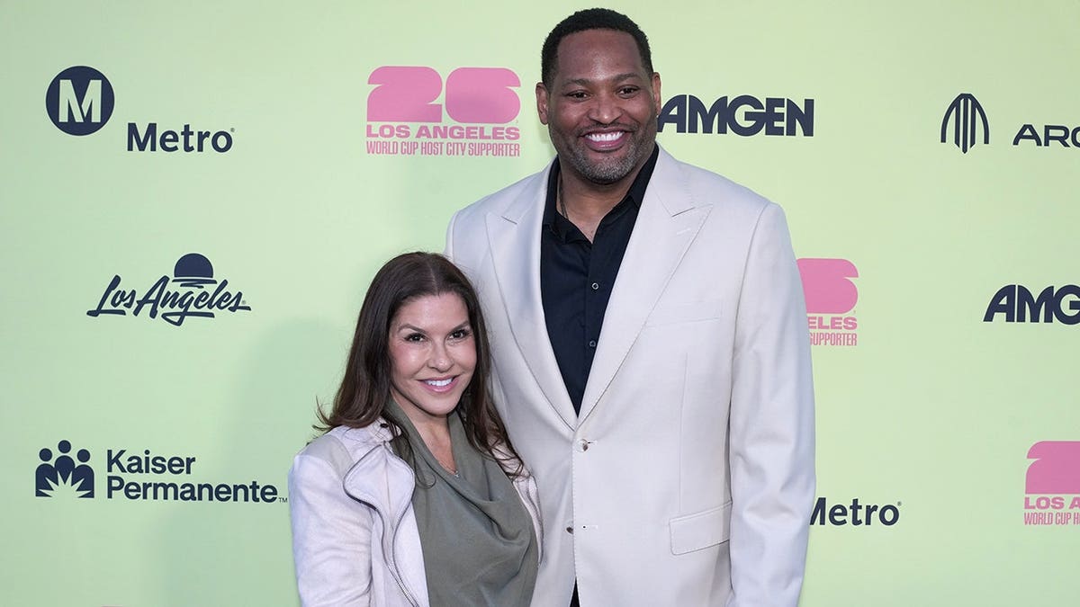 Robert Horry and Candice Horry posing on the blue carpet at the World Cup 2026 Kickoff Party