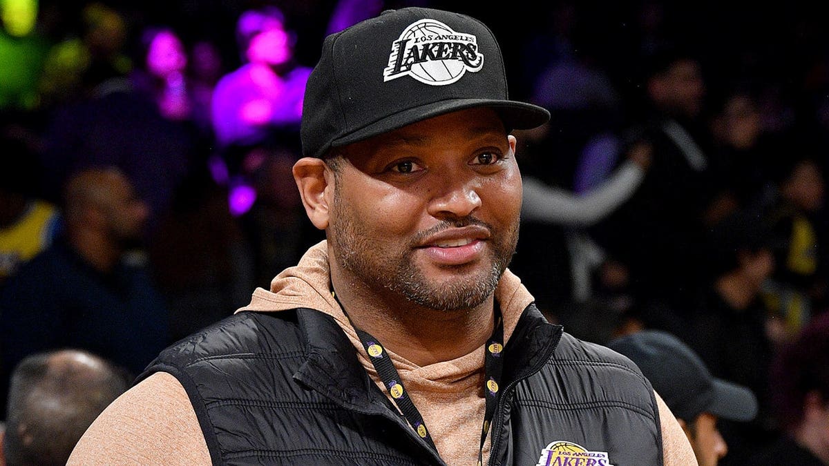 Robert Horry standing courtside at a basketball game at Crypto.com Arena in Los Angeles