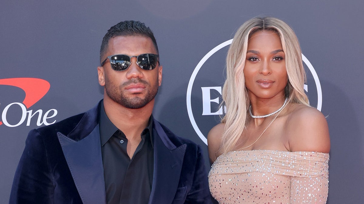 Russell Wilson and Ciara standing together on the red carpet at the ESPY Awards