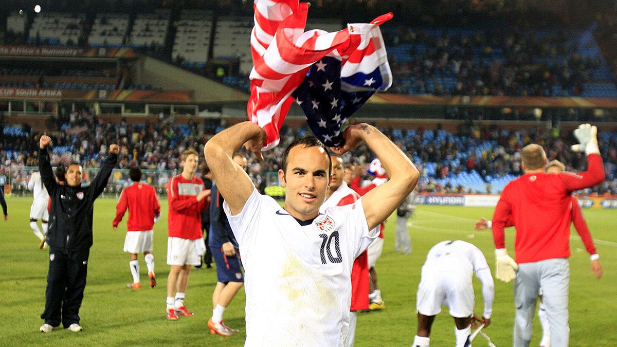 Landon Donovan celebrating victory holding American flag at 2010 World Cup