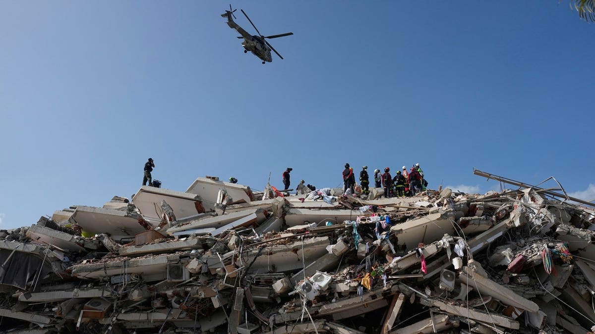 Rescue workers search through the rubble three days after earthquakes struck Catia la Mar, Venezuela