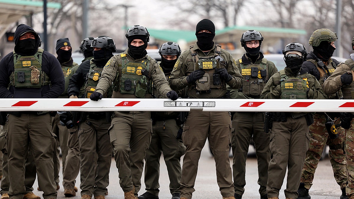 US Border Patrol agents standing guard outside the Bishop Henry Whipple Federal Building in Minneapolis