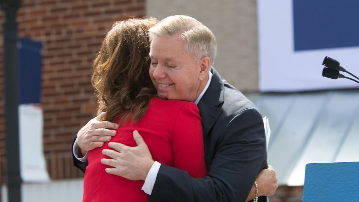 U.S. Sen. Lindsey Graham (R-SC) hugs his sister Darline Graham Nordone on stage as he announces his candidacy for United States President during an outdoor event for supporters on June 1, 2015 in Central, South Carolina.