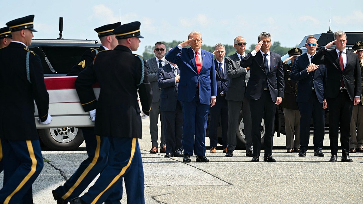 US President Donald Trump salutes as a US Army carry team carries the flag-draped transfer case containing the remains of 1st Lt. Tyler James Feehan, 25, of Ewa Beach, Hawaii, during a dignified transfer solemn event for US service members killed during operations in the Middle East, at Dover Air Force Base in Dover, Delaware, on July 22, 2026. Feehan was killed in action on July 18 during an enemy attack at Muwaffaq Salti Air Base in Jordan. (Photo by SAUL LOEB / AFP via Getty Images)