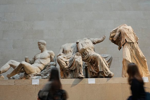 Visitors walk past part of the Parthenon Marbles at the British Museum in London. 