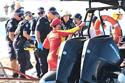 Emergency workers at the scene of the helicopter collision near Sea World.