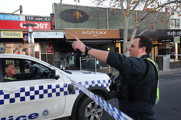 Police at the cafe on Friday after the shooting.