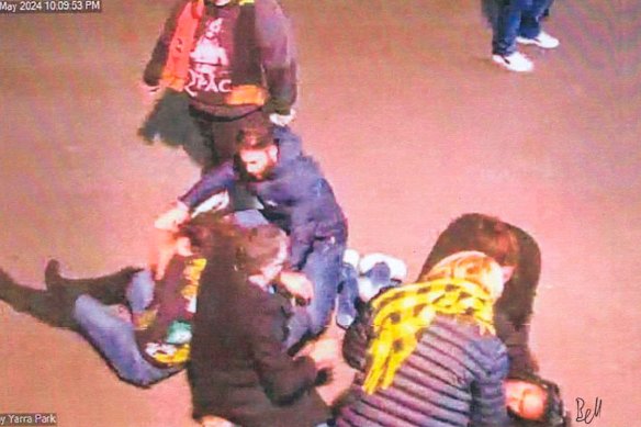 Lidia Thorpe, wearing black boots and a Richmond guernsey, is pictured on the ground outside the MCG.