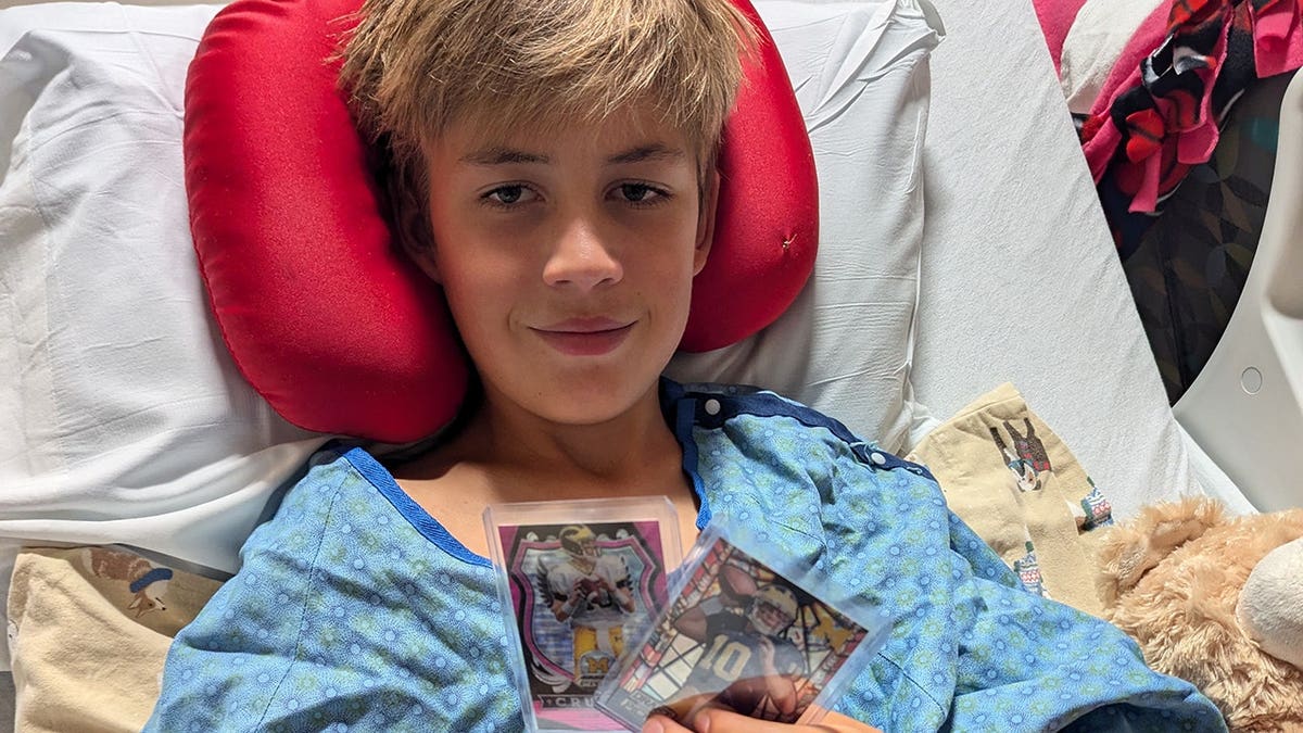 Eli Griffith in hospital with Tom Brady cards