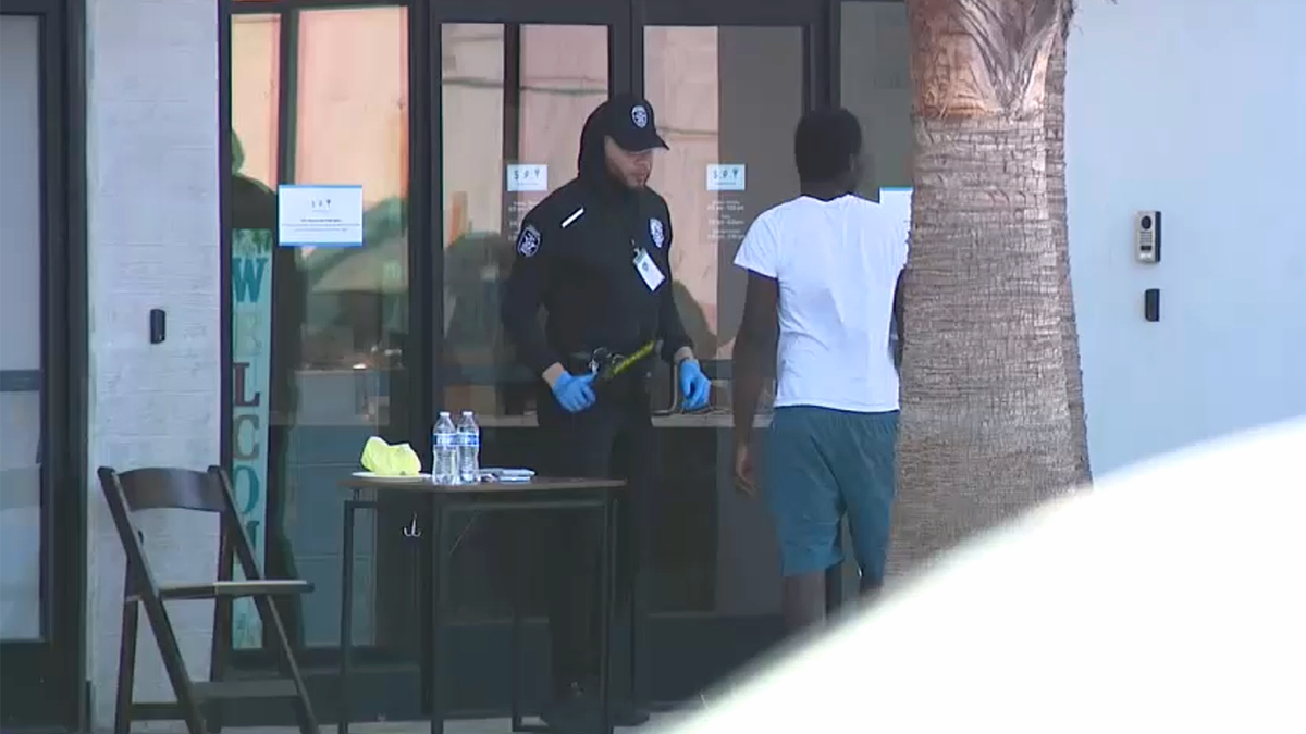A security guard stands outside a supportive housing facility in Venice, California