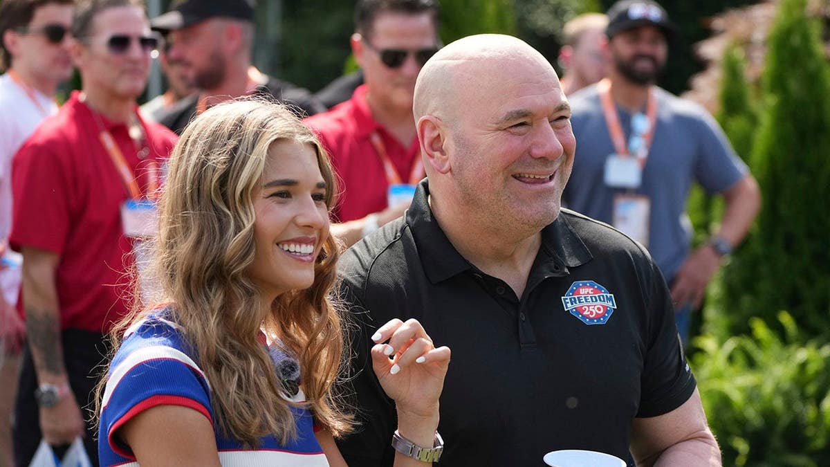 Kai Trump and Dana White watch a motorcycle jump on the White House South Lawn.