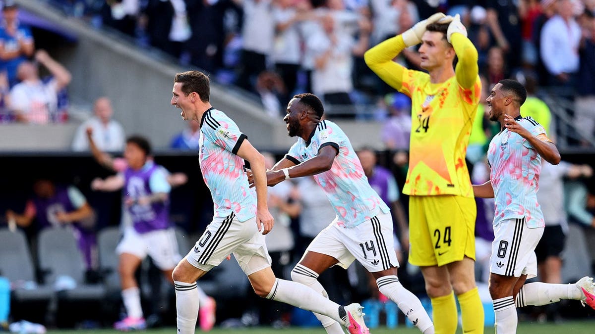 Hans Vanaken celebrates with Dodi Lukebakio and Youri Tielemans as Matt Freese looks on.