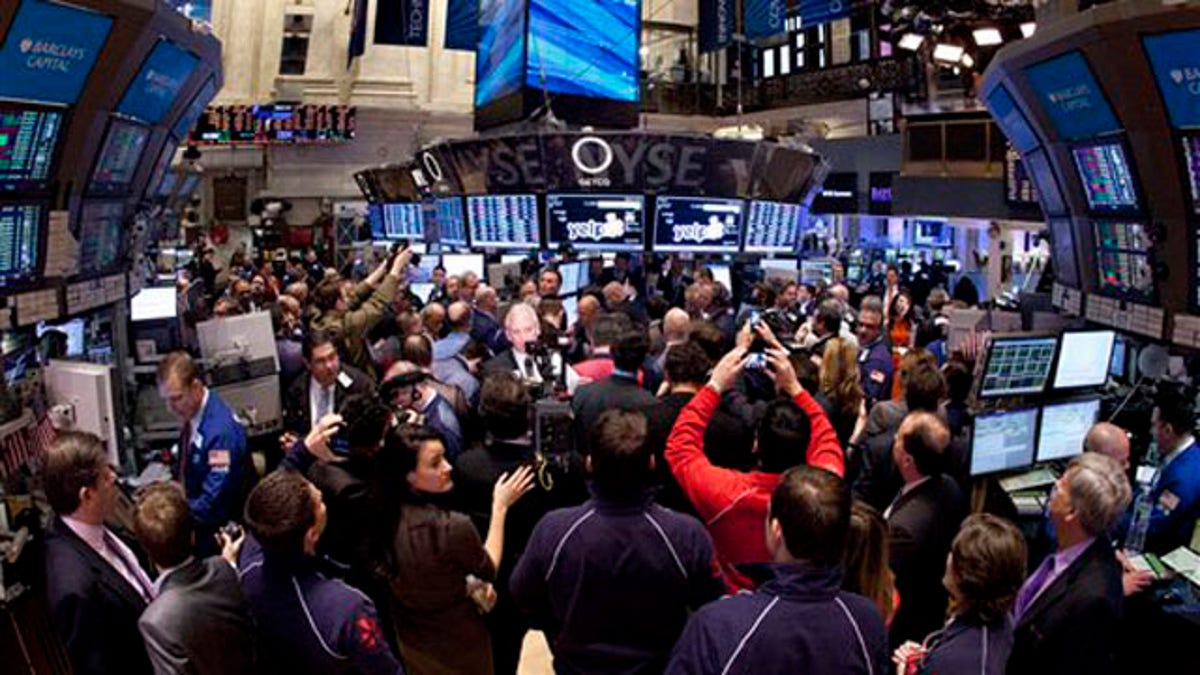 March 2, 2012: Traders crowd on the floor of the New York Stock Exchange.